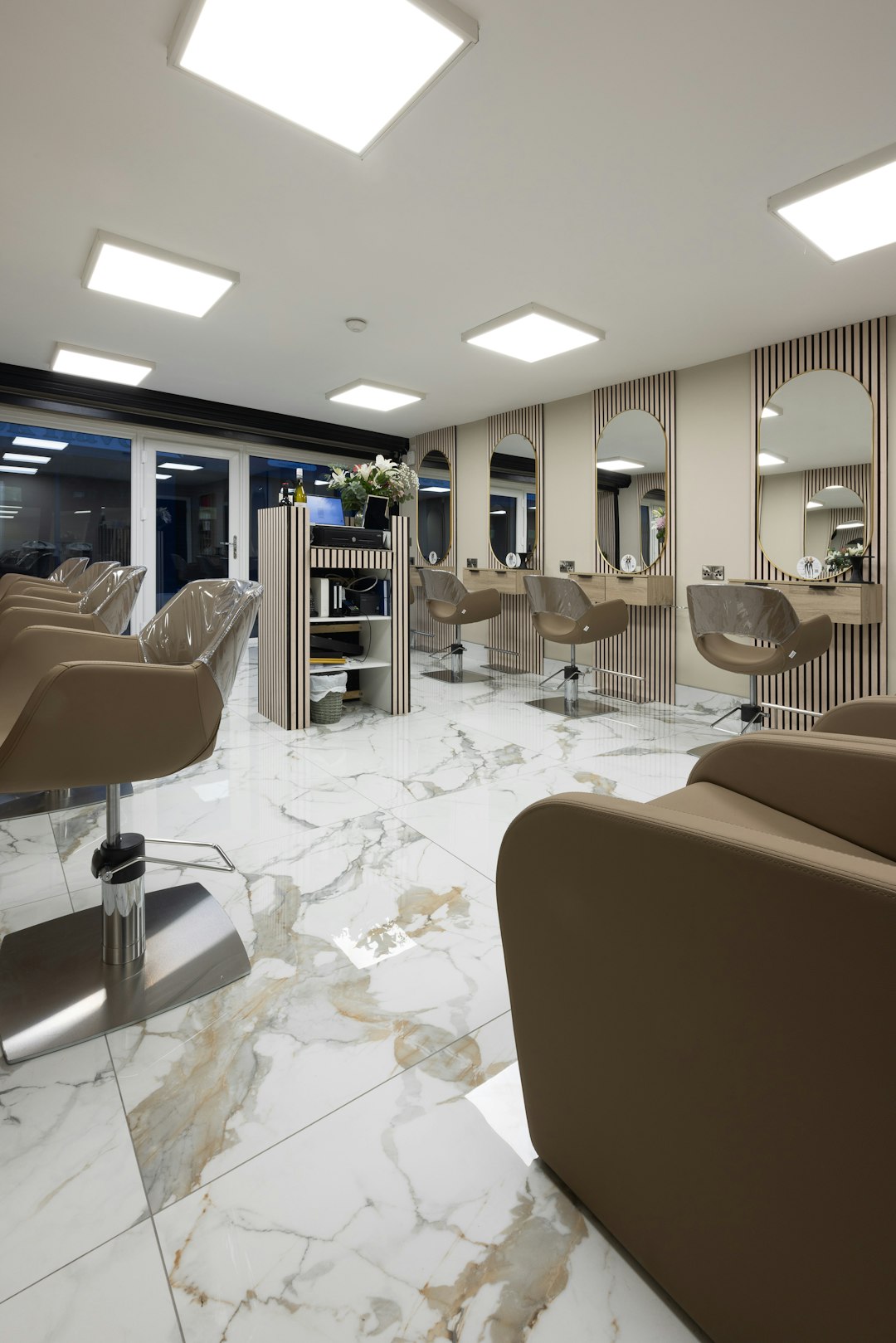 Using just marble effect tiles and wall panels Tile merchant Ireland turned a fairly ordinary hair salon into a Mediterranean marvel, fit to wow their customers. As you can see from the photographs featured here, this Irish salon owner used our popular Bianco Platino marble-effect indoor porcelain tiles to design a brand-new shop floor. They also added some tastefully placed Cool Oak acoustic wall panels behind each mirror and bordering their till point, for an extra dash of modernist style. www.tilemerchant.ie